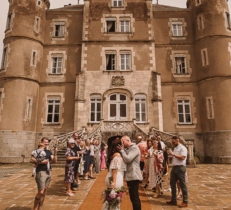 A couple kiss infront of the French chateau from Escapte To The Chateau