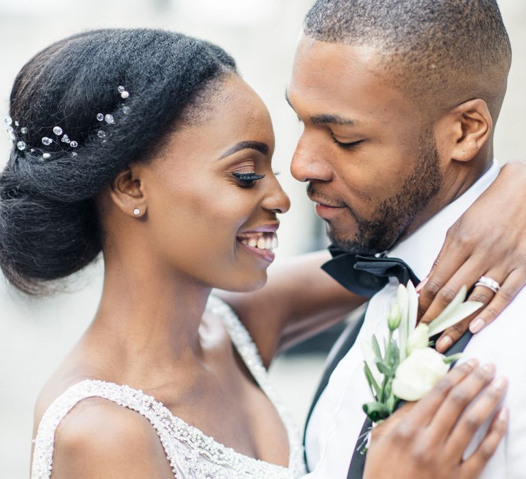 Bride & groom smile at one another 