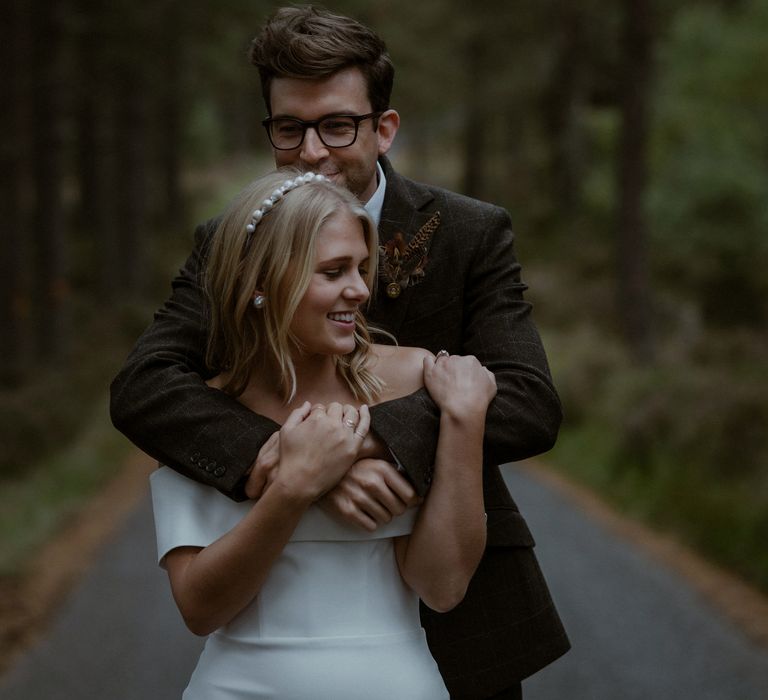 Bride & groom embrace during Scotland elopement outdoors