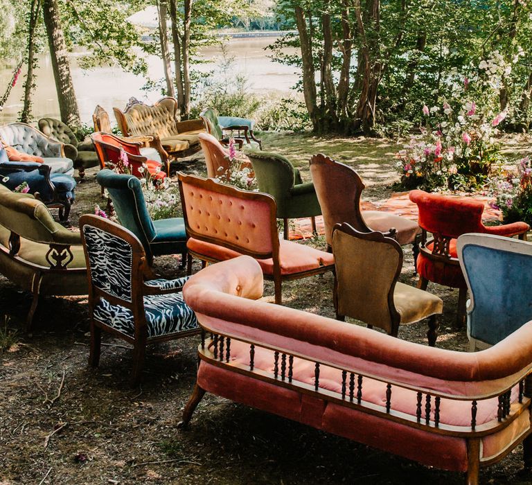 Outdoor wedding ceremony with different chairs and sofas 