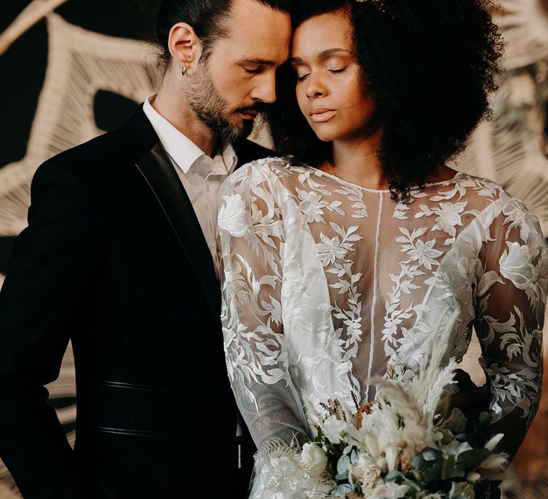 Bride & groom stand together on the day of their wedding