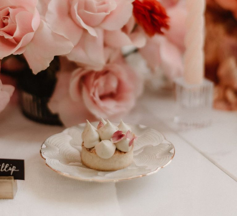 Pink and peach wedding flowers with a meringue topped pastry