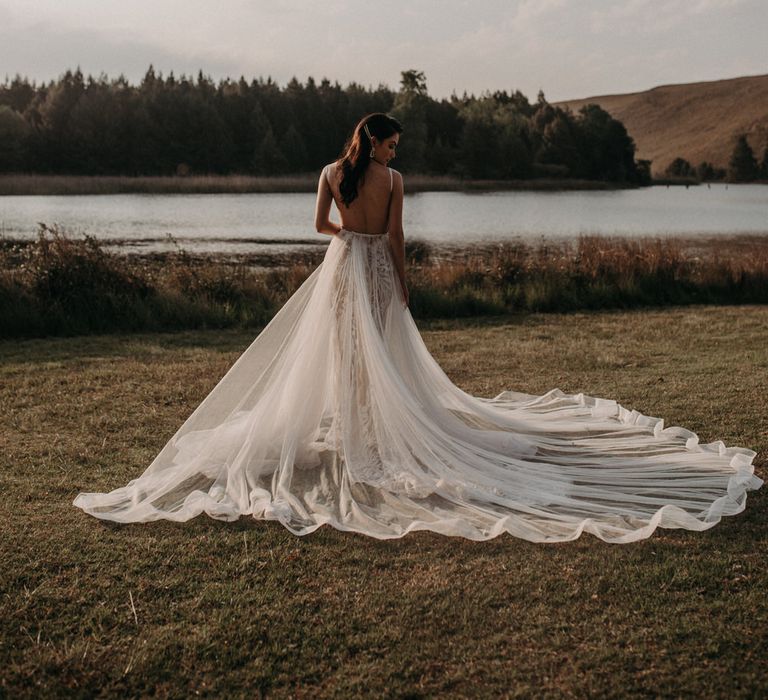 Bride wearing a layered tulle wedding dress at golden hour for moody romantic wedding shoot