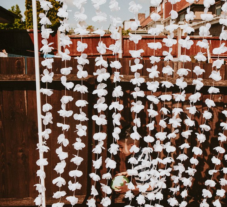 String of white flower wedding decor at garden party wedding 