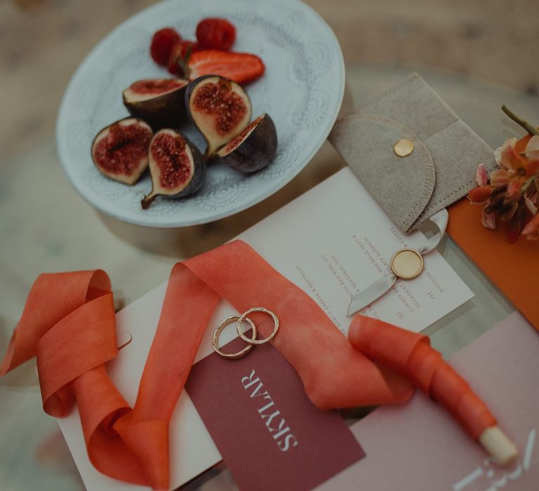 Corals and peach tone wedding stationery with silk ribbons