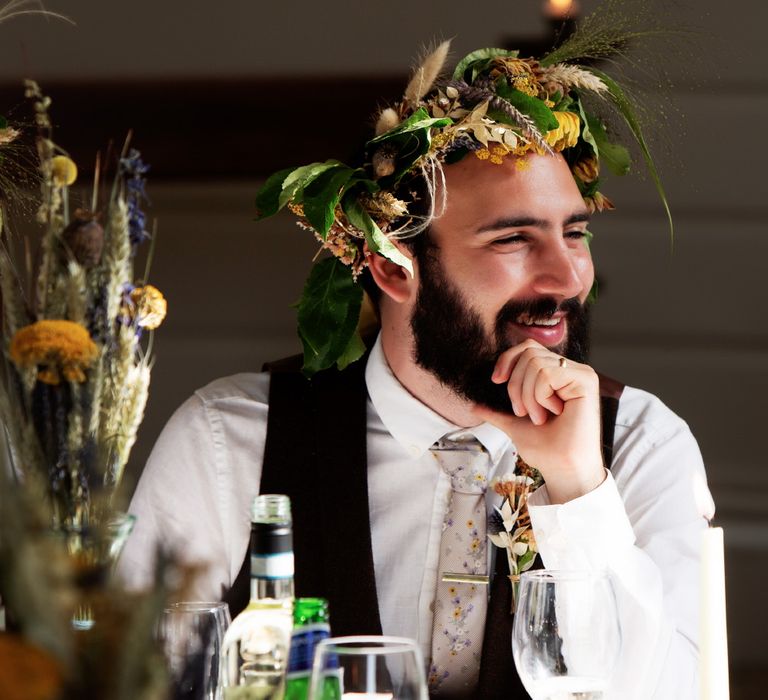 Groom laughs and look toward friend on his wedding day