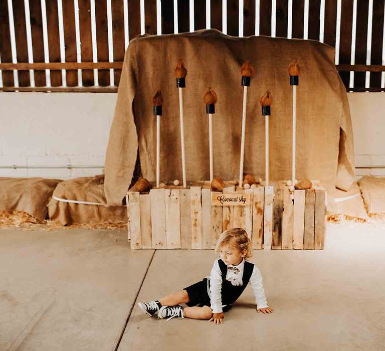 Little boy in converse for wedding infront of DIY wedding games