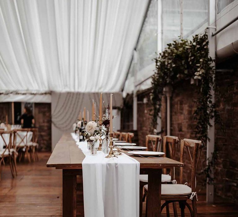 Simple elegant dinner table settings with foliage flowers at Cefn Tilla Court 