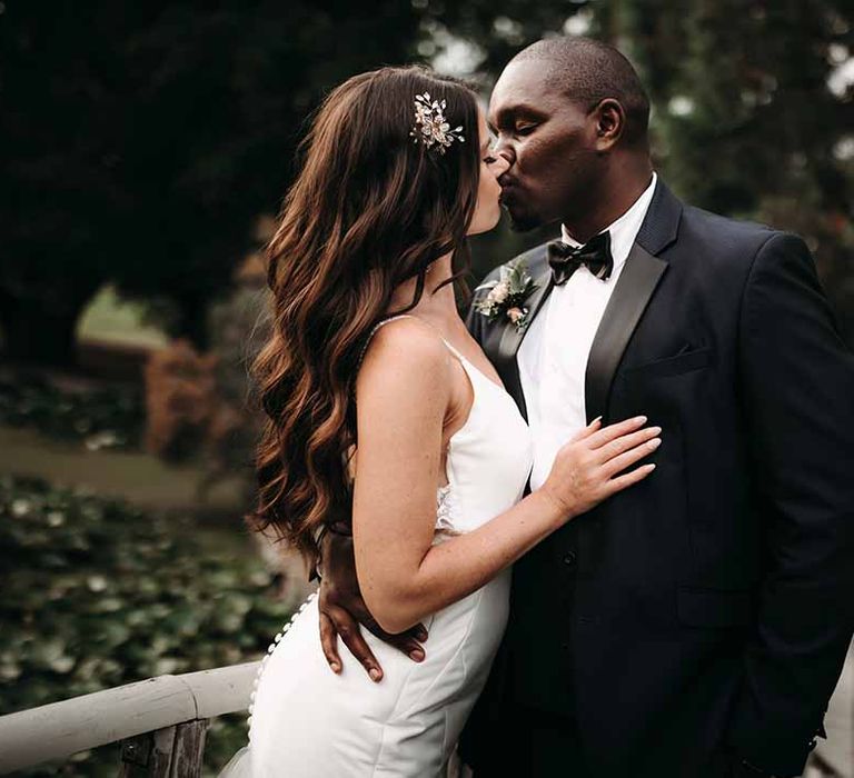 Bride & Groom look lovingly at each other as they stand in their outside ceremony 