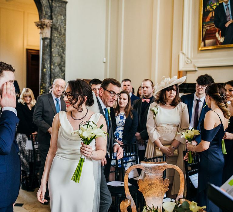 Bride holds lily bouquet 