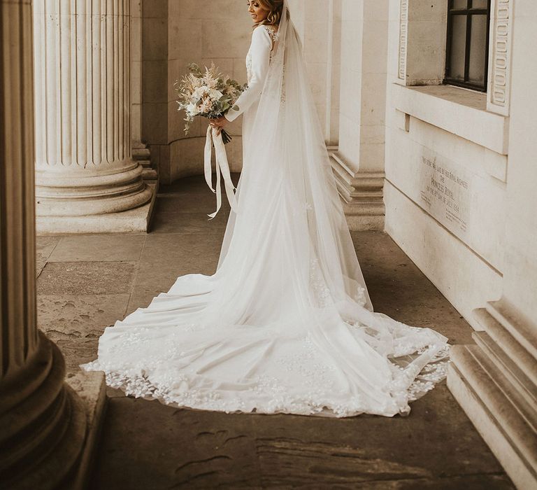 Beautiful bride in a Pronovias, lace back wedding dress with puddle train and cathedral length gown