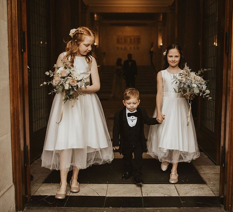 Flower girls and page boys in taffeta dresses and mini suit 