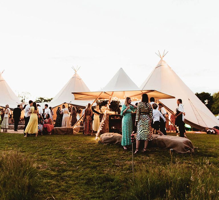 Wedding party stand outdoors for festival styled wedding