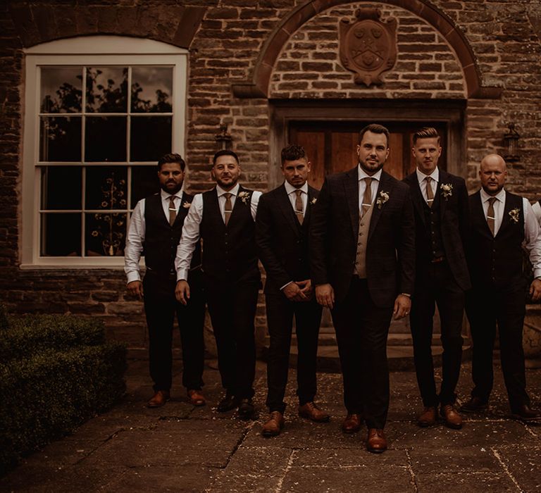 Groom and groomsmen in check suits at Dewsall Court wedding 