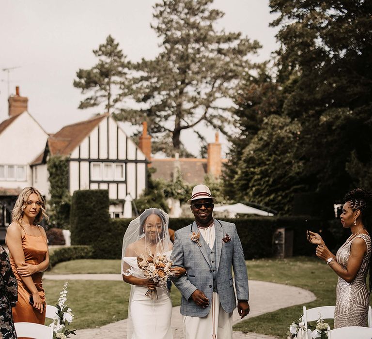 Bride walks down the aisle with her father on her wedding day