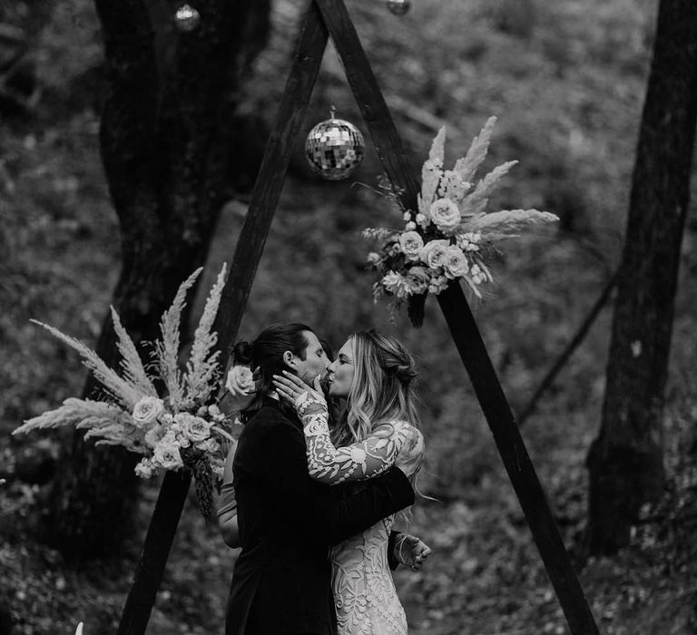 Bride & groom kiss outdoors 