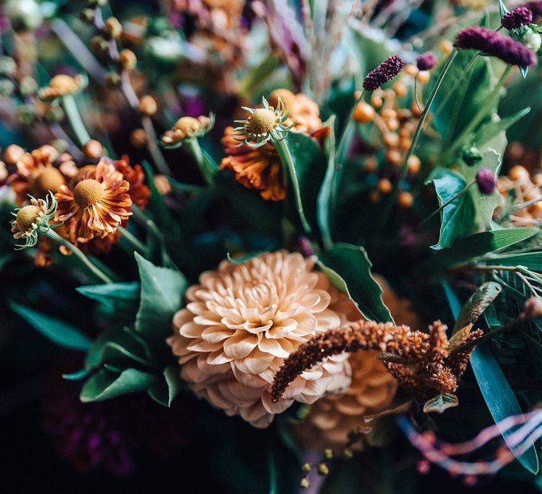 Autumnal wedding bouquet with orange, purple and red flowers