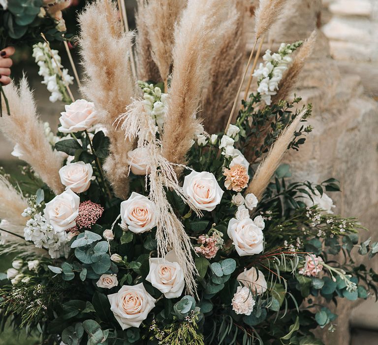 Blush pink rose and pampas grass floral arrangements 