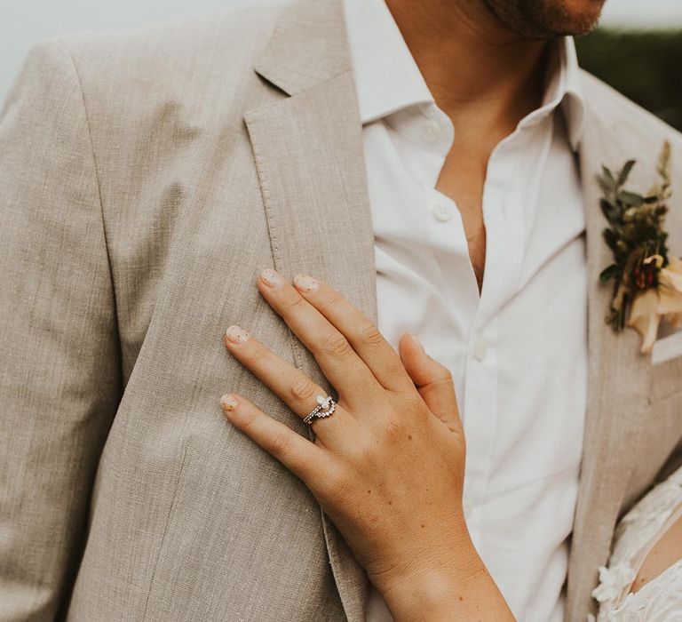 Bride wears an engagement ring and wedding band that fit together 