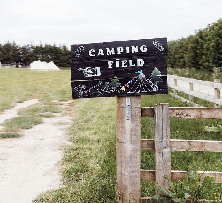 Black wooden painted camping sign for the clamping at Deepdale Farm venue 