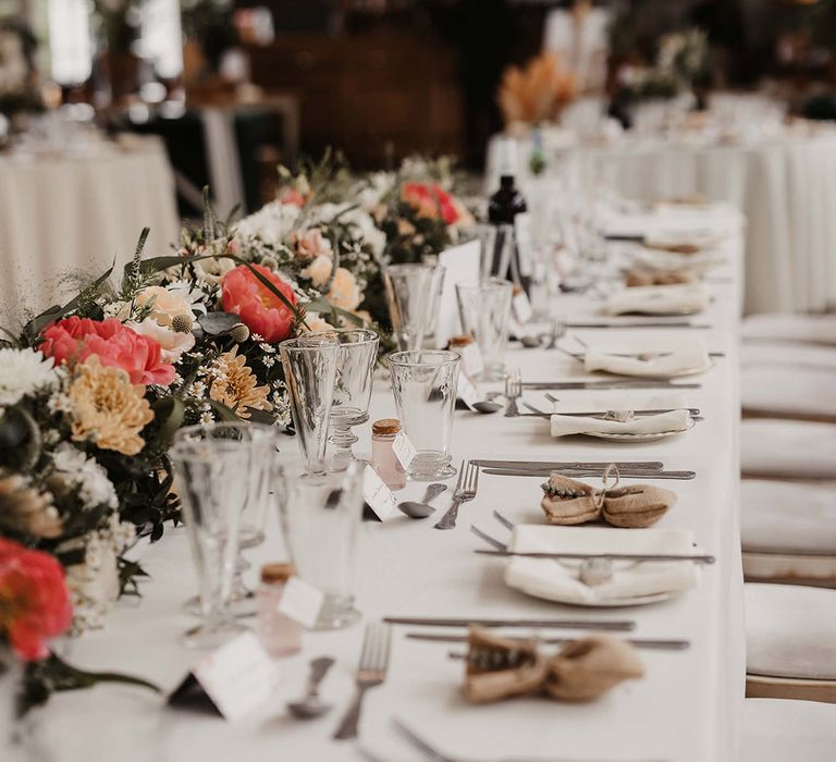 Red, orange and white wedding flower decorations with shot wedding favours