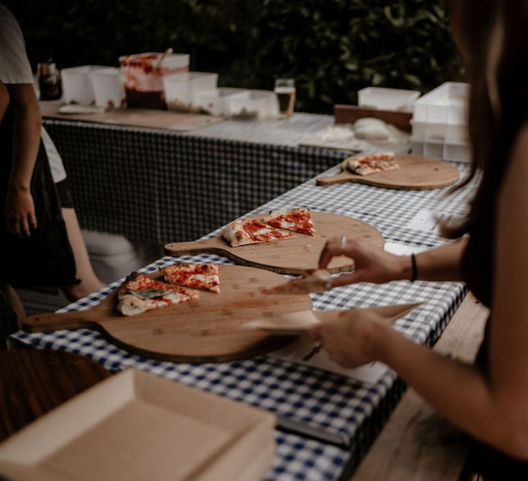 Guests help themselves to slices of pizza for the evening food 