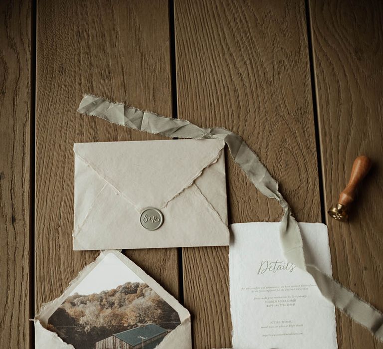 White, cream, and sage green vintage wedding stationery with ribbons and wax seals 