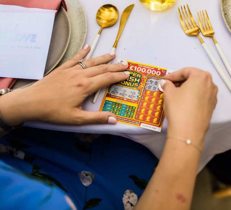 Wedding guest scratching off lottery card for wedding favour idea 