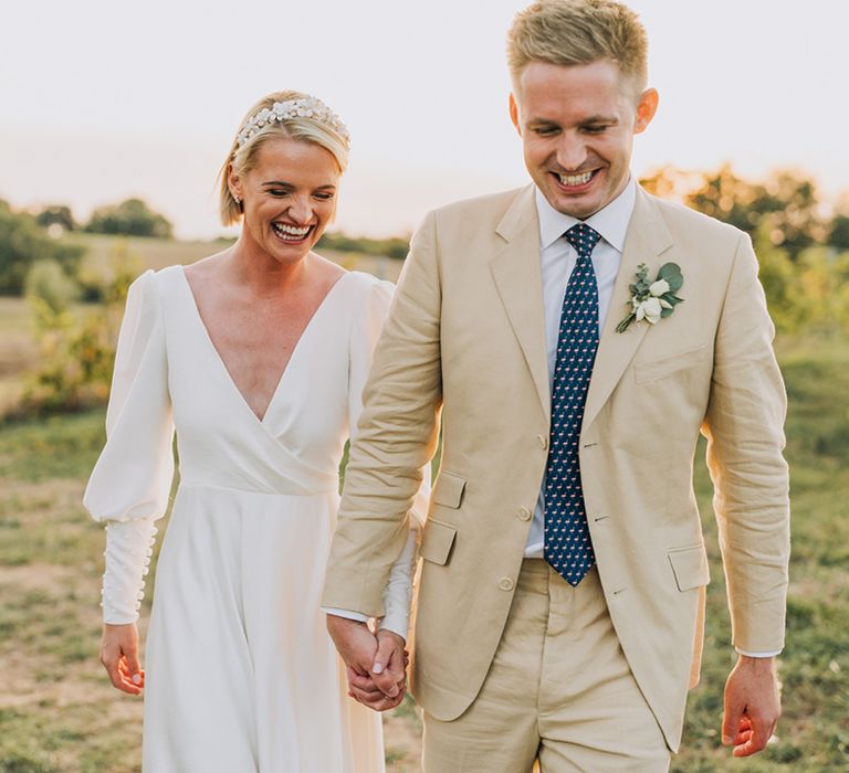 golden hour wedding photograph at Château de Malliac with groom in a stone suit and bride in a bespoke wedding dress