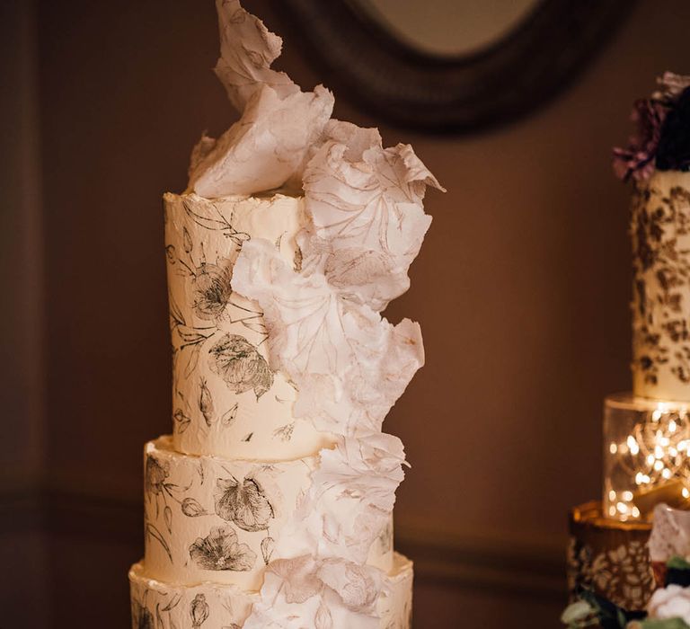 Three tier buttercream frosted wedding cake with black rose decoration and 3D sugar paper decoration 