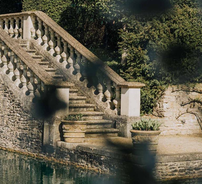 Euridge Manor wedding venue gardens with grand stone staircase going down to lake and water feature 