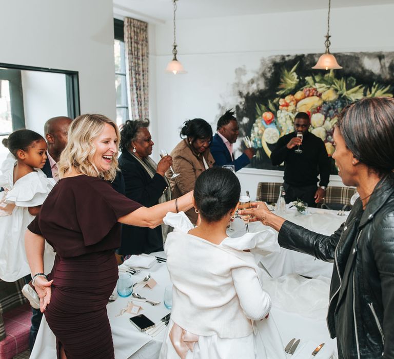 Wedding guests sit together at intimate wedding venue 