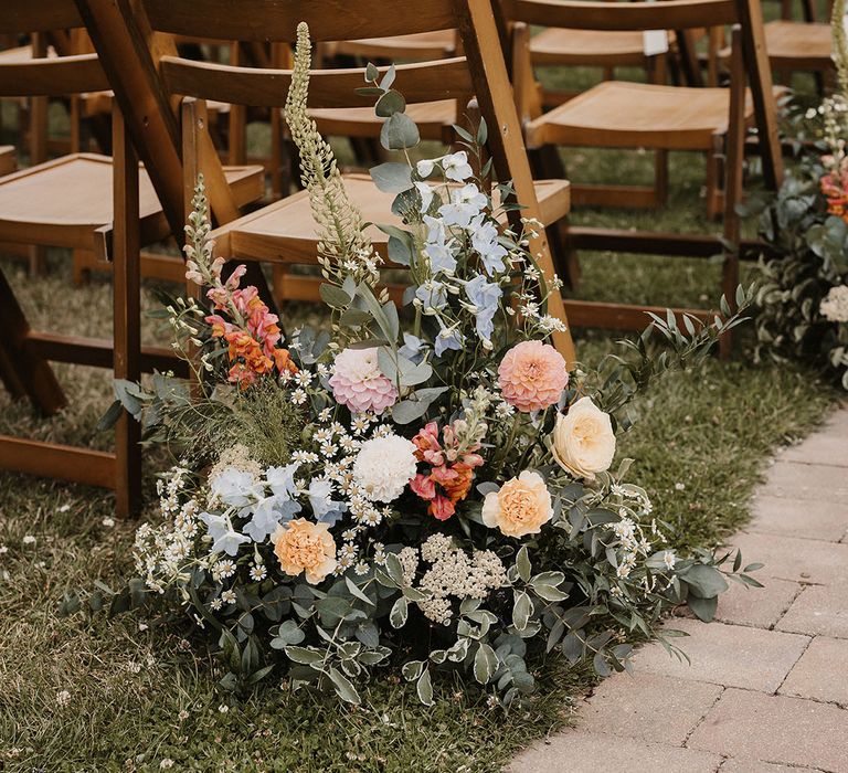 Meadow aisle wedding flowers made up of flowers in pastel colours 