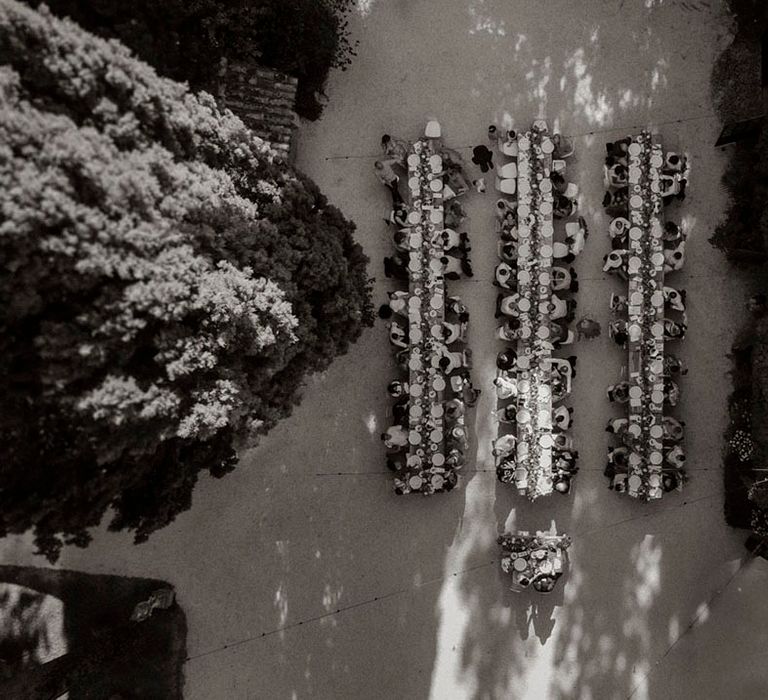 Long tables at outdoor wedding breakfast Italian destination wedding 