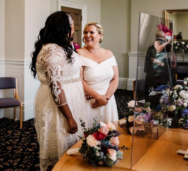 Brides laughing at wedding ceremony in Liverpool 