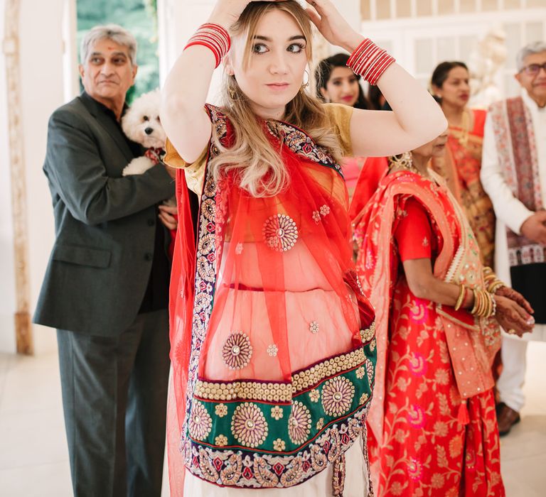 Bridesmaid in traditional safari earring pots on her head 