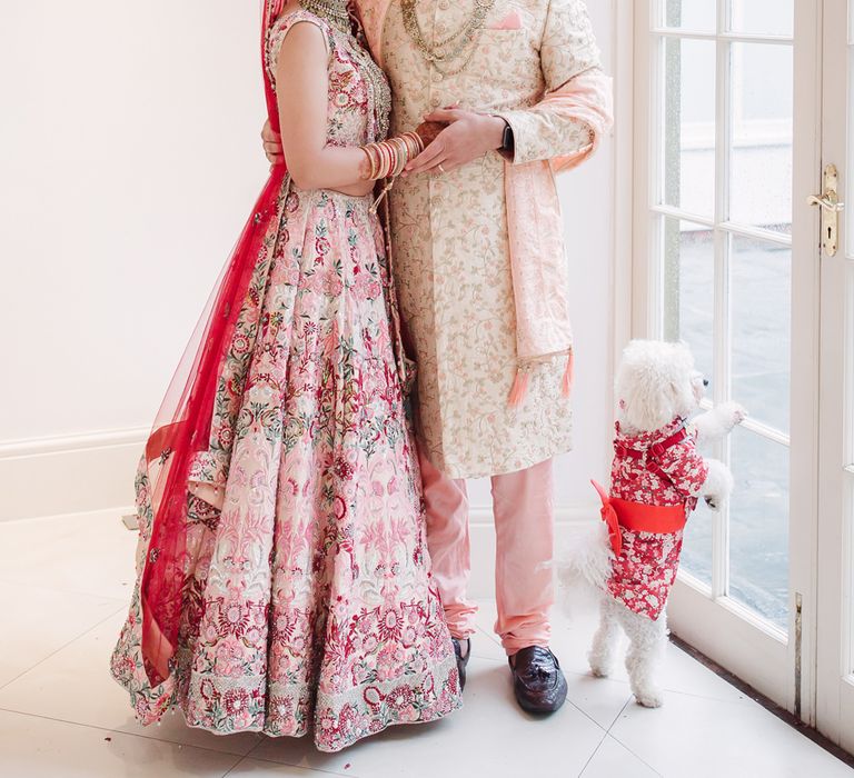 Bride and groom wedding portrait in pink dress and suit at Northbrook Park 