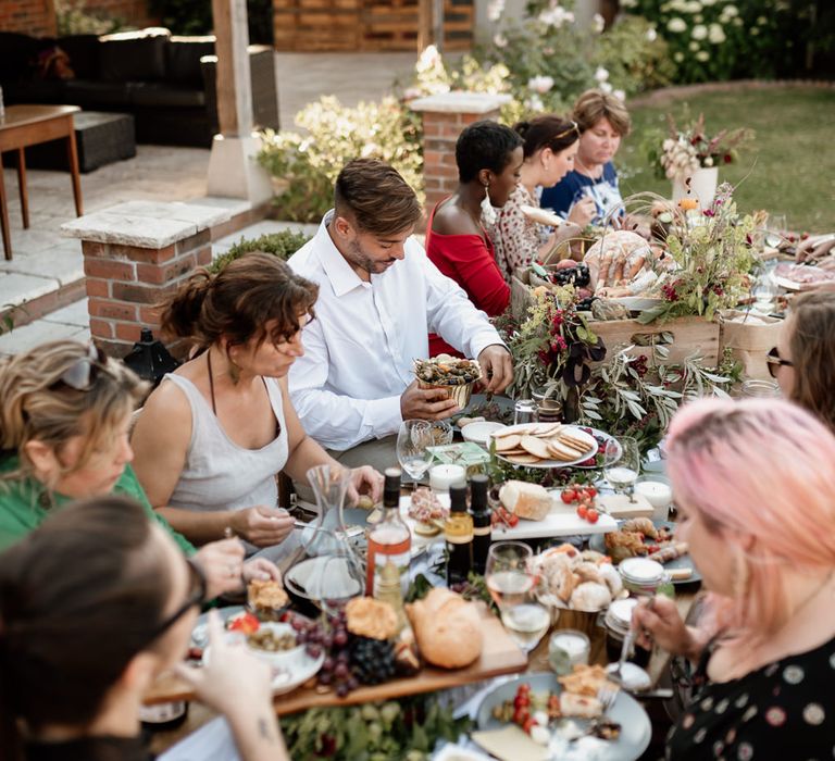 Outdoor alfresco wedding reception with graze tables and festoon lights 