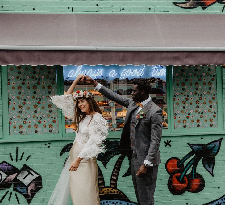 Bride and Groom dance outside doughnut stand