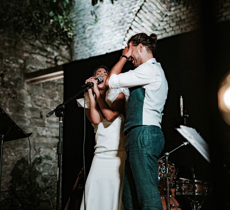 Bride and groom singing at Italian destination wedding reception 