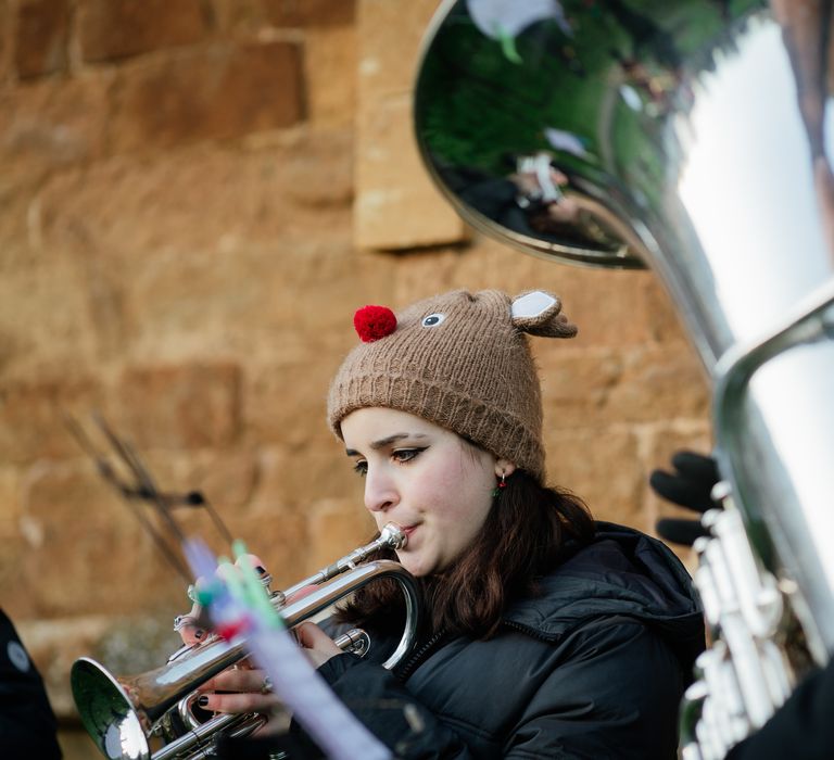 Brass band plays outdoors 