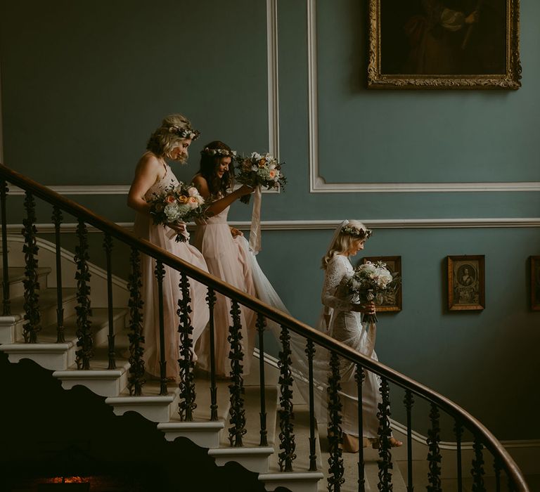 Bride in Grace Loves Lace Wedding Dress, single tier cathedral length veil and flower crown walking down stairs with bridesmaids at Drenagh Estate wedding 