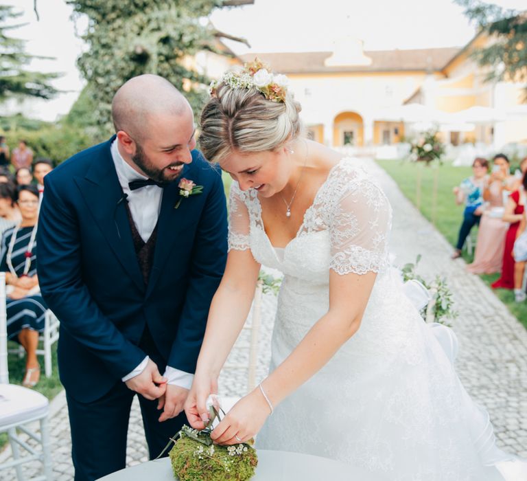 The bride and groom giggling to each other as they get married