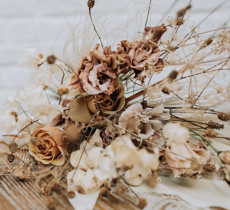 Neutral dried flower bouquet with wild grasses and roses for all white wedding inspiration