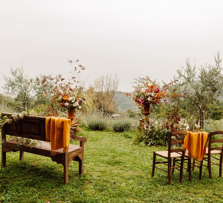 Intimate outdoor wedding ceremony set up in a misty olive grove for couple who elope in Italy