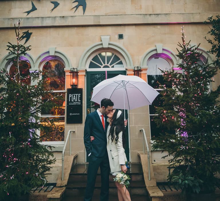 Bride and groom kissing outside the bird bath - bride wears short wedding dress