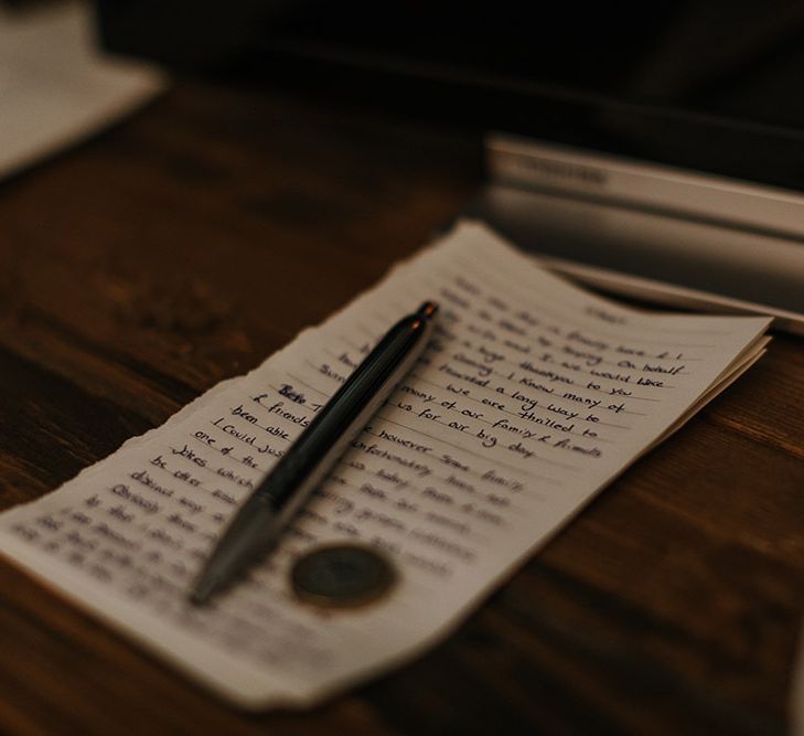 Wedding vows written on a piece of note paper with a pen.