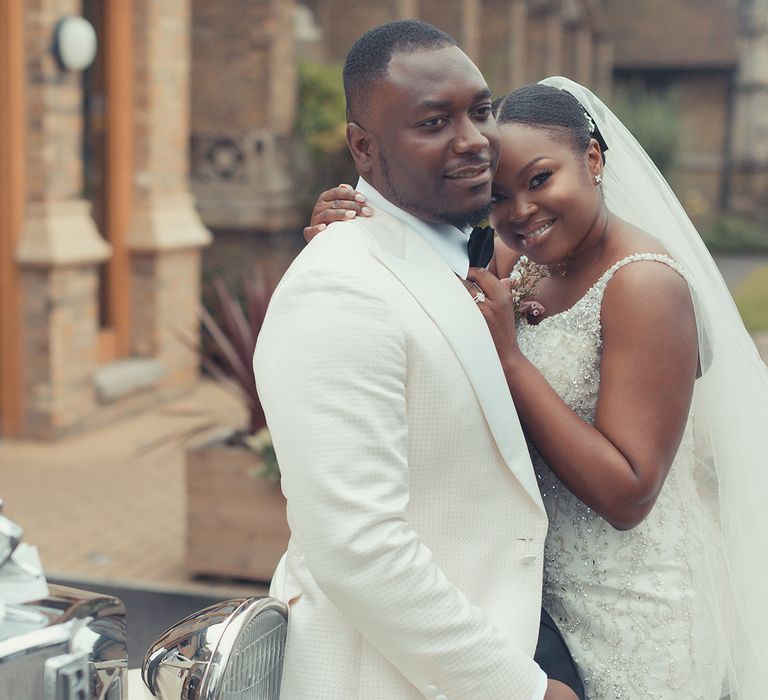 Bride leans her head against grooms chest as they post for post-wedding photos