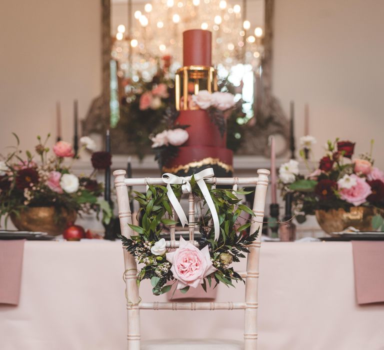 Floral hoop chair back wedding decor with foliage, roses and ribbon 