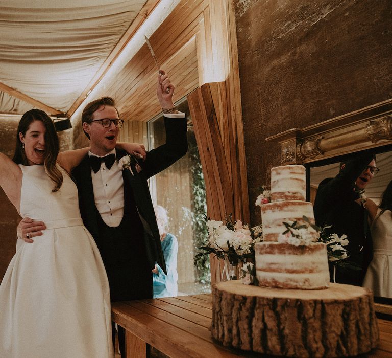 Bride & groom celebrate after they cut their cake